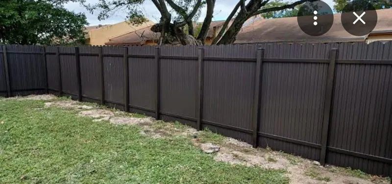 Black aluminum privacy fence along a residential boundary