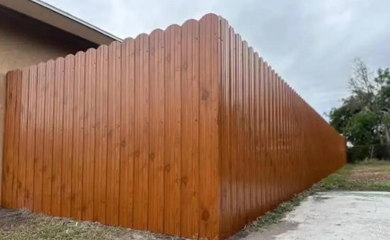 Brown aluminum privacy fence section at a Florida home