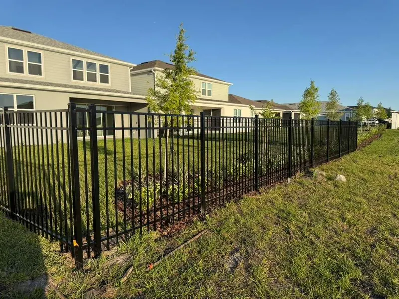Black ornamental aluminum fence detail with vertical pickets