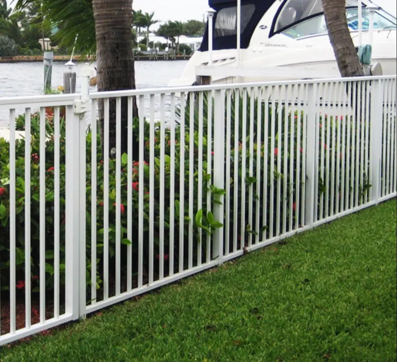 White aluminum ornamental fence along a yard