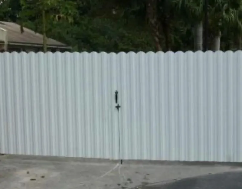 White aluminum privacy fence section in a Florida yard