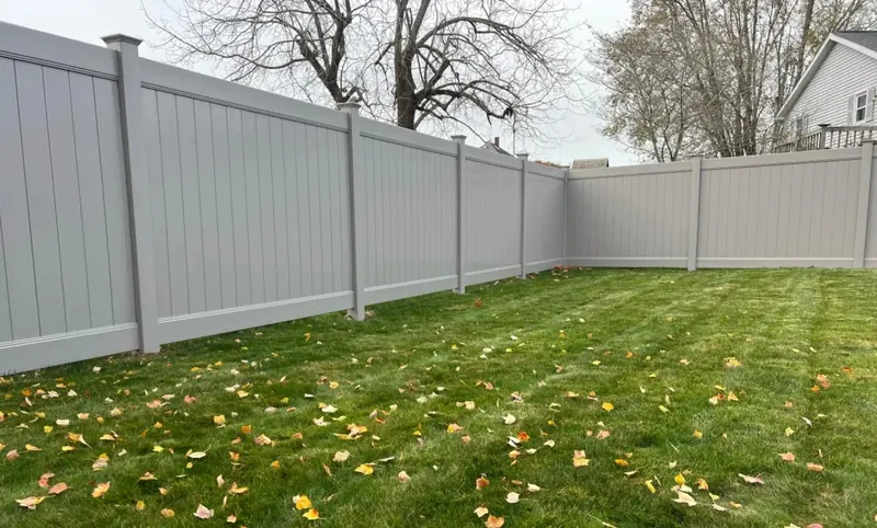 Gray vinyl privacy fence installed along a Florida residential property line