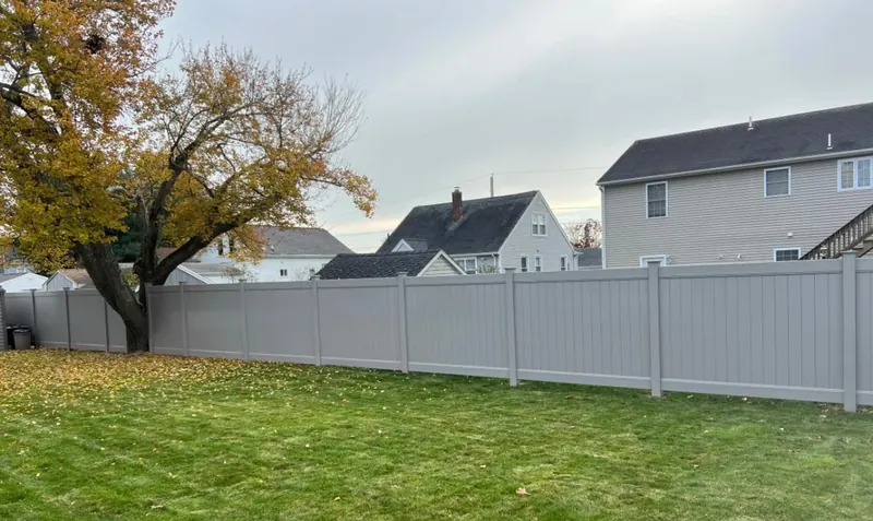 Gray vinyl privacy fence section in a Central Florida backyard