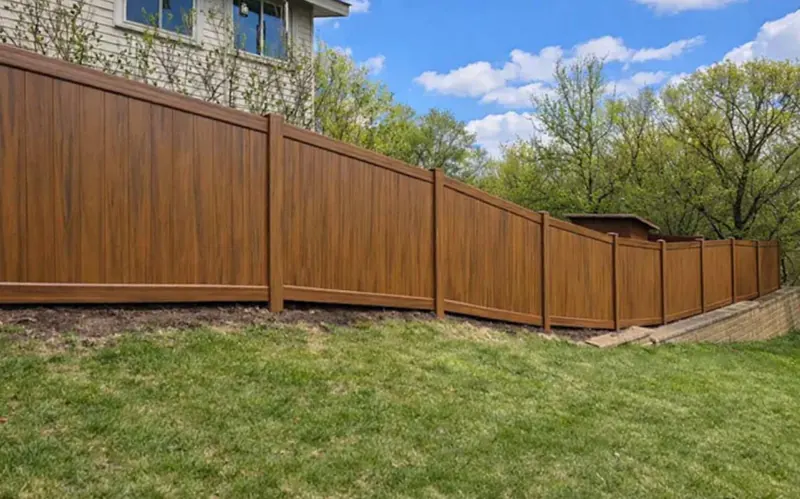 Mocha wood-grain vinyl privacy fence with matching gate
