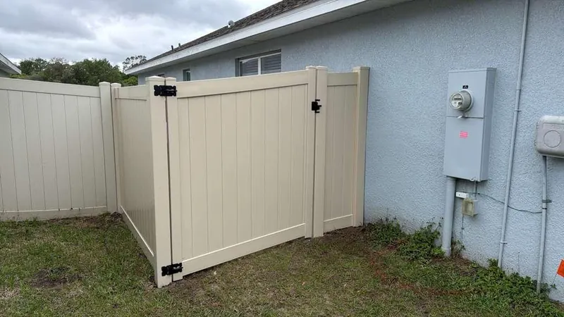 White vinyl privacy fence with matching gate
