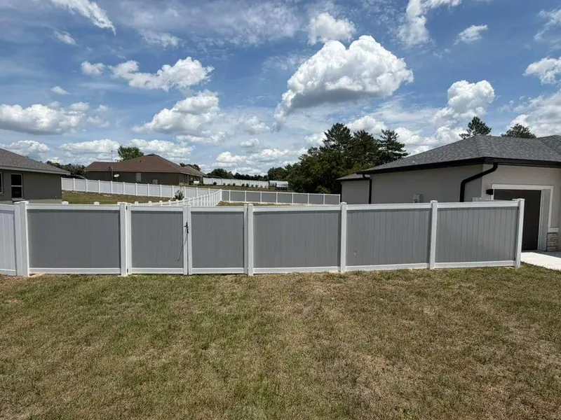 White vinyl privacy fence framing a backyard space