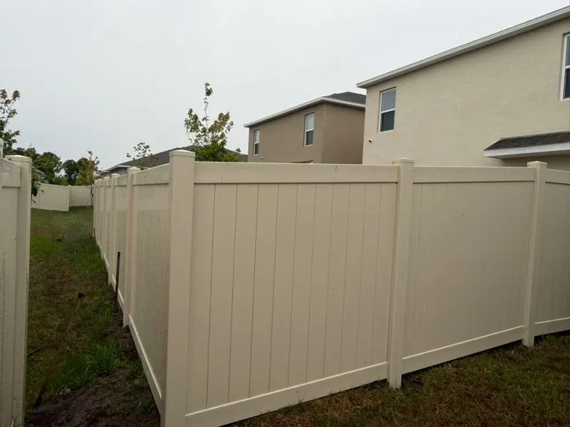 White vinyl privacy fence detail with post caps