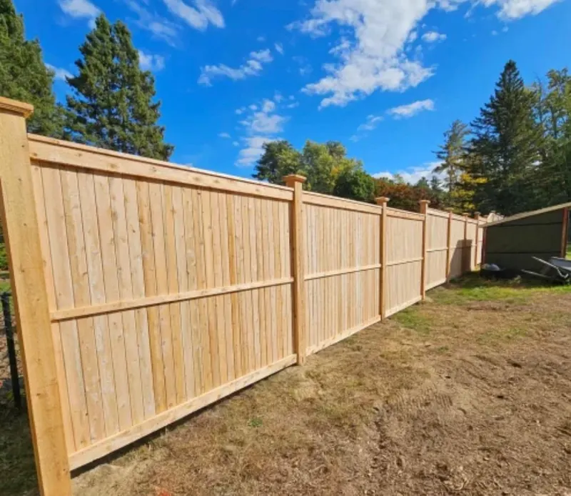 Wood fence detail with post caps in a Florida yard